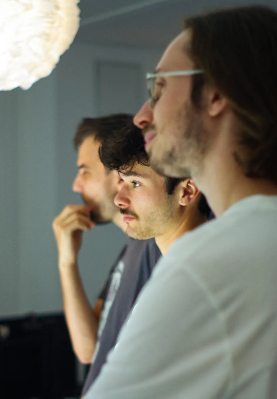 Part of the Arkyan team gathered around a screen during a working session